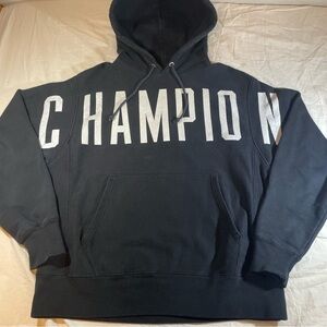 Black Champion Reverse Weave hoodie with white "Champion" print